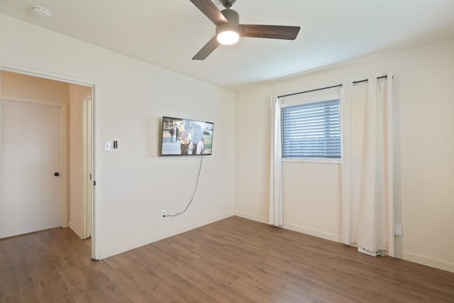 1016 N White St, Hanford, CA 93230 - unfurnished room with baseboards, a ceiling fan, and wood finished floors
