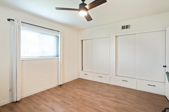1016 N White St, Hanford, CA 93230 - unfurnished bedroom with visible vents, a ceiling fan, light wood-style floors, baseboards, and two closets
