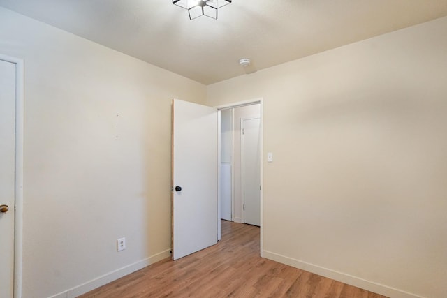 1016 N White St, Hanford, CA 93230 - unfurnished bedroom with baseboards and light wood-style flooring