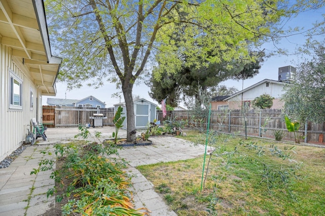 1016 N White St, Hanford, CA 93230 - view of yard with a patio area, a fenced backyard, a storage unit, and an outdoor structure