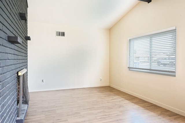 1016 N White St, Hanford, CA 93230 - unfurnished living room featuring baseboards, wood finished floors, visible vents, and vaulted ceiling