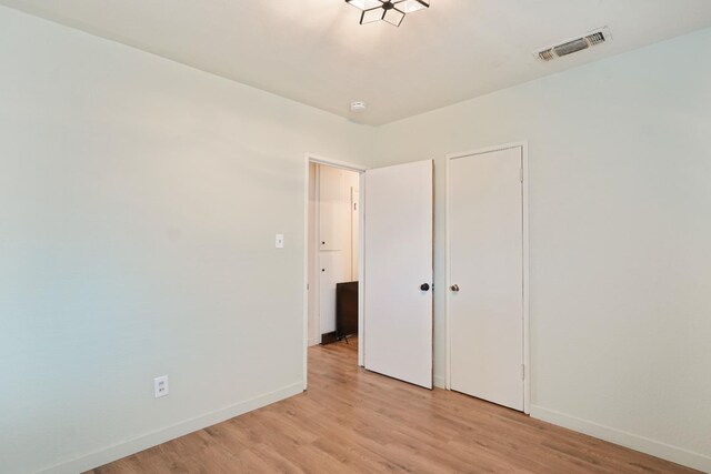 1016 N White St, Hanford, CA 93230 - unfurnished bedroom with baseboards, light wood-style floors, and visible vents