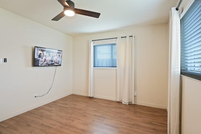 1016 N White St, Hanford, CA 93230 - spare room with ceiling fan, a wealth of natural light, and light wood-style flooring