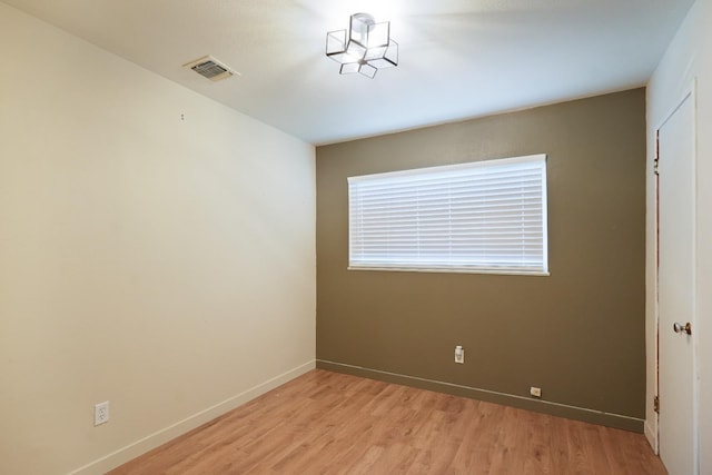 1016 N White St, Hanford, CA 93230 - spare room featuring light wood-type flooring, baseboards, and visible vents