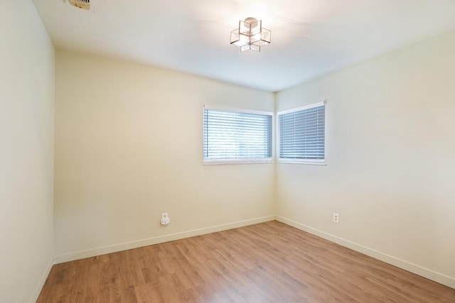1016 N White St, Hanford, CA 93230 - spare room featuring baseboards and light wood-style flooring