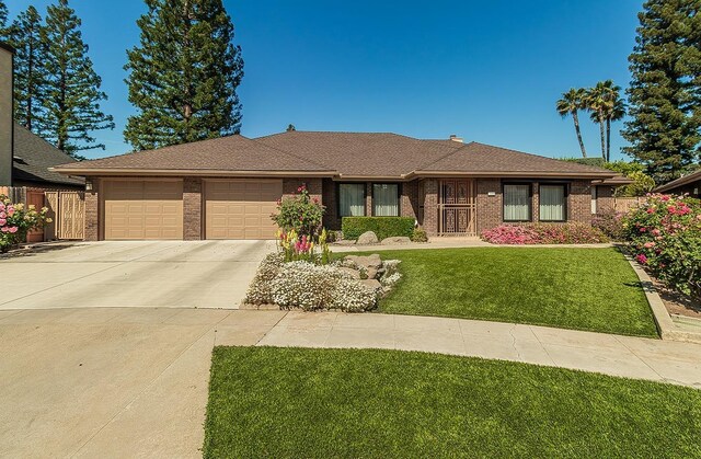 7355 N Pacific Ave, Fresno, CA 93711 - ranch-style house featuring concrete driveway, brick siding, a front yard, and a garage