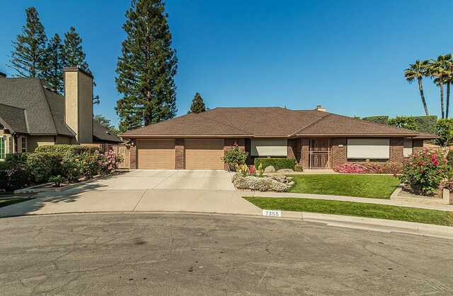 7355 N Pacific Ave, Fresno, CA 93711 - single story home featuring a chimney, a front lawn, an attached garage, driveway, and brick siding