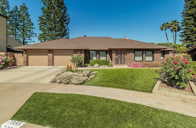 7355 N Pacific Ave, Fresno, CA 93711 - view of front facade with roof with shingles, concrete driveway, an attached garage, brick siding, and a front yard