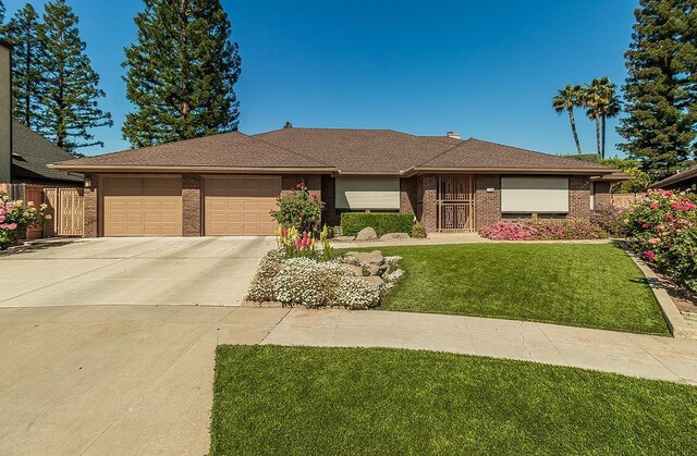 7355 N Pacific Ave, Fresno, CA 93711 - ranch-style home with fence, an attached garage, driveway, brick siding, and a front yard