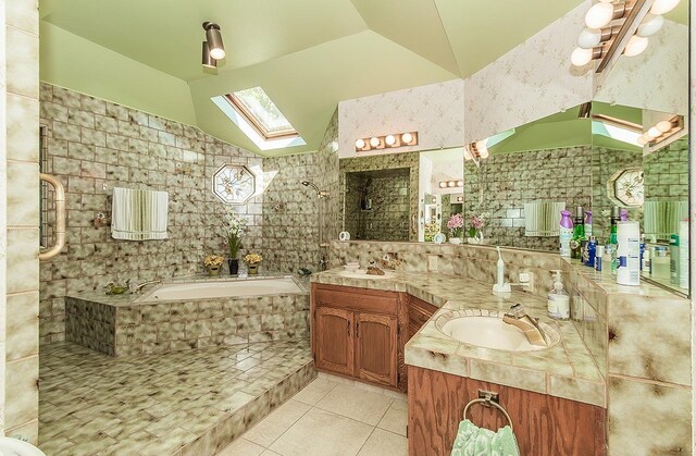 7355 N Pacific Ave, Fresno, CA 93711 - bathroom featuring a bath, tile patterned floors, a sink, tiled shower, and vaulted ceiling with skylight