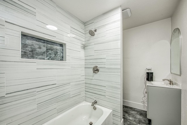 bathroom with bathing tub / shower combination, baseboards, and vanity