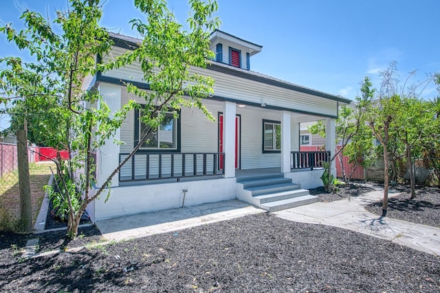 view of front of home featuring fence and covered porch