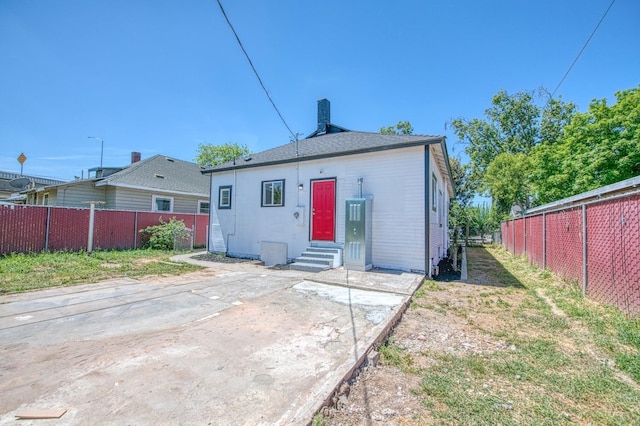 back of house with fence, a patio area, a chimney, and entry steps