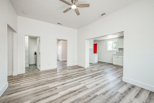 unfurnished bedroom with light wood-style floors, visible vents, and baseboards