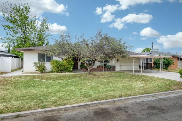 ranch-style house with concrete driveway, fence, a front yard, and stucco siding