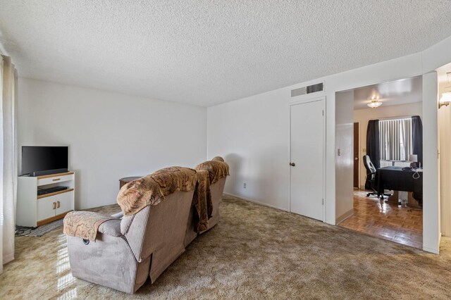 4311 N Emerson Ave, Fresno, CA 93705 - living area with a textured ceiling, visible vents, and carpet