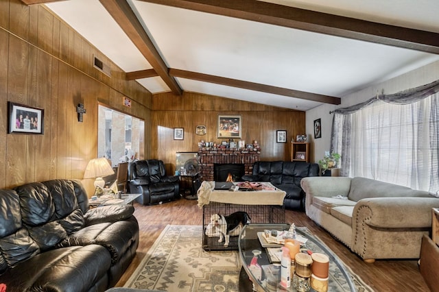 4311 N Emerson Ave, Fresno, CA 93705 - living area with wooden walls, wood finished floors, visible vents, and vaulted ceiling with beams