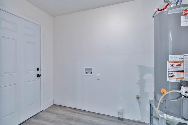 227 E Pine Ave, Fresno, CA 93728 - washroom with water heater, washer hookup, light wood-style flooring, and hookup for an electric dryer