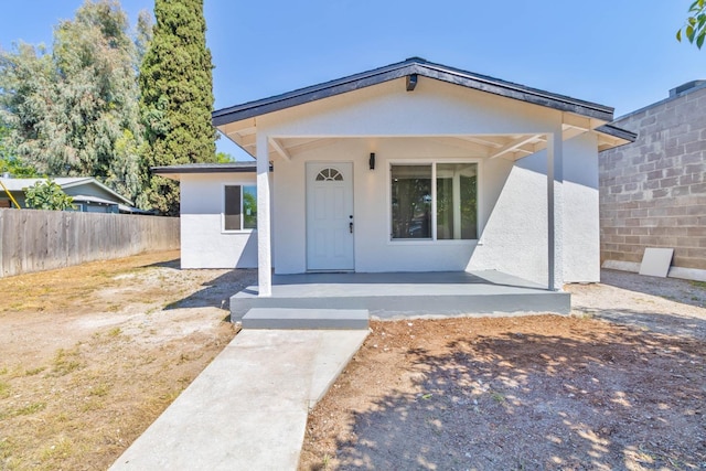 227 E Pine Ave, Fresno, CA 93728 - view of front of home featuring covered porch and stucco siding