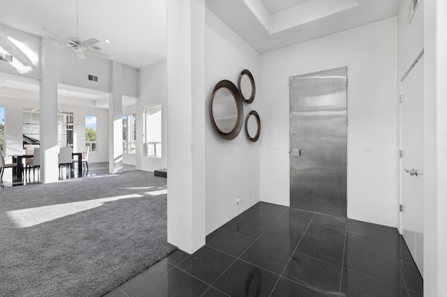 corridor with recessed lighting, dark carpet, dark tile patterned floors, and visible vents