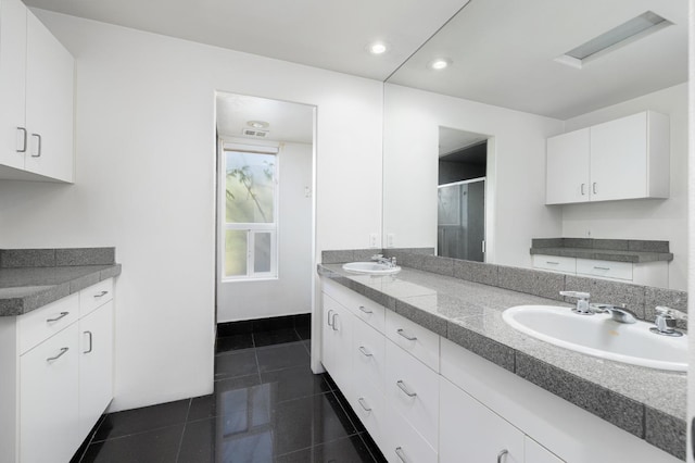 full bath featuring a sink, double vanity, and a stall shower