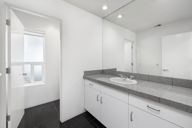 bathroom featuring tile patterned floors, visible vents, and vanity