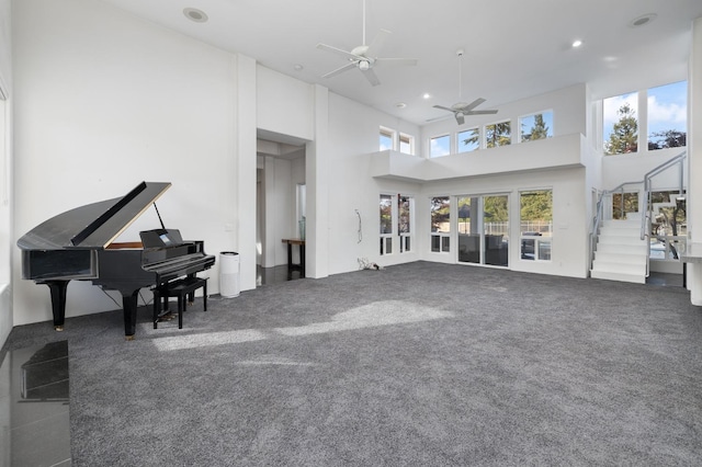 living room with a ceiling fan, carpet, recessed lighting, and stairway
