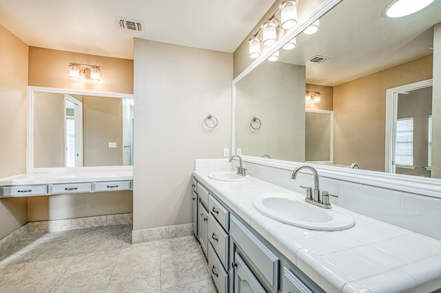 5711 W Fallon Ave, Fresno, CA 93722 - bathroom featuring baseboards, visible vents, and a sink