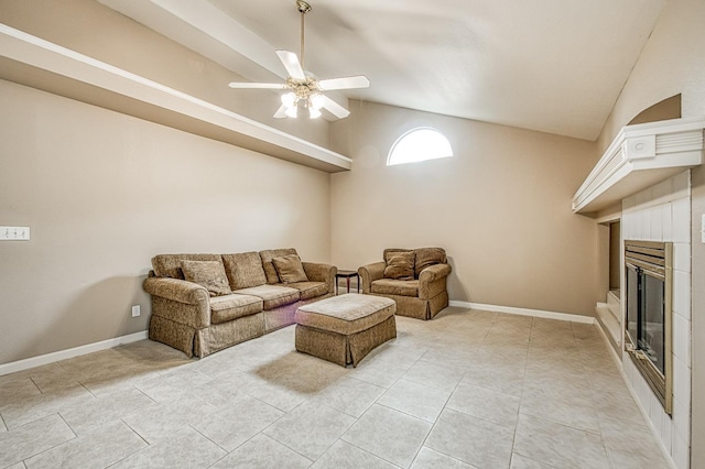 5711 W Fallon Ave, Fresno, CA 93722 - living area featuring baseboards, a glass covered fireplace, lofted ceiling, ceiling fan, and light tile patterned floors