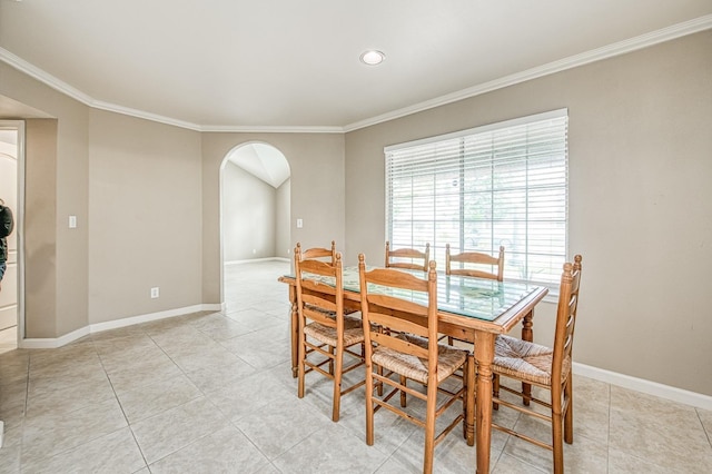 5711 W Fallon Ave, Fresno, CA 93722 - dining room with baseboards, arched walkways, crown molding, and light tile patterned floors