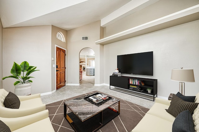 5711 W Fallon Ave, Fresno, CA 93722 - tiled living room with baseboards, visible vents, arched walkways, and high vaulted ceiling