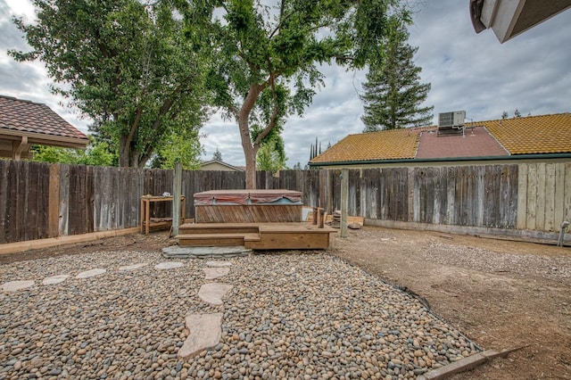 5711 W Fallon Ave, Fresno, CA 93722 - view of yard with a fenced backyard, a hot tub, and central air condition unit
