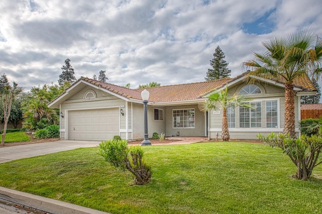 5711 W Fallon Ave, Fresno, CA 93722 - view of front of home with a tile roof, driveway, an attached garage, a front yard, and stucco siding