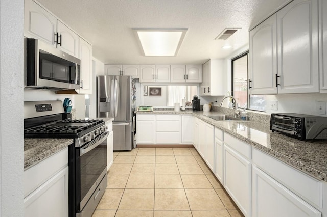 3375 N Berlin Ave, Fresno, CA 93722 - kitchen with light stone countertops, stainless steel appliances, visible vents, and a sink