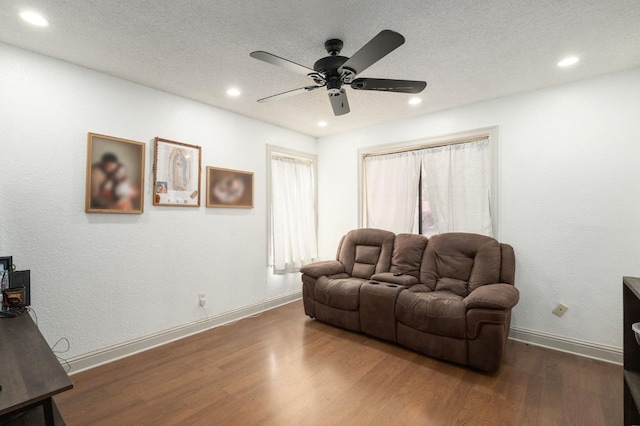 3375 N Berlin Ave, Fresno, CA 93722 - living area featuring a ceiling fan, a textured ceiling, baseboards, dark wood-style flooring, and recessed lighting