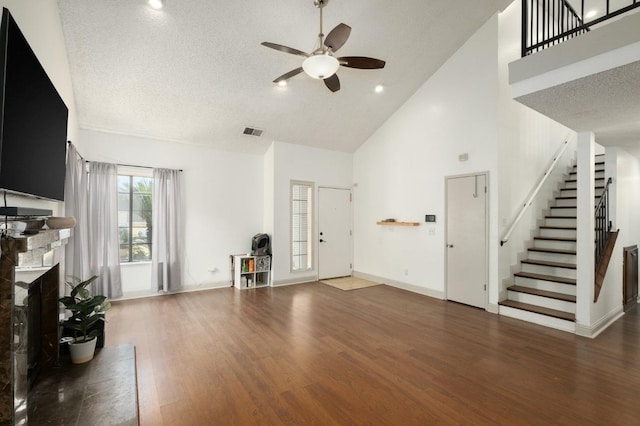 3375 N Berlin Ave, Fresno, CA 93722 - unfurnished living room with visible vents, wood finished floors, stairs, ceiling fan, and high vaulted ceiling