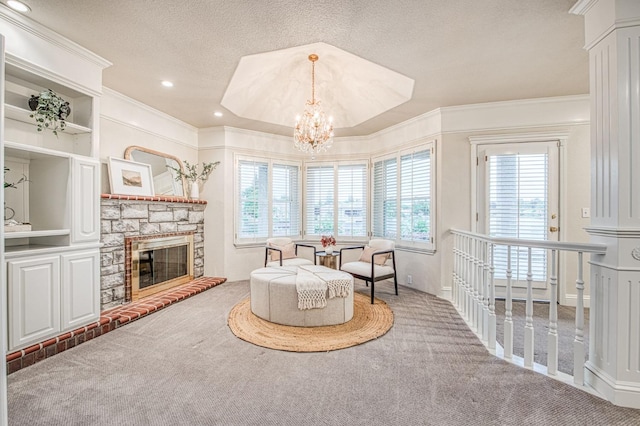 sitting room with a textured ceiling, carpet, a notable chandelier, and ornamental molding