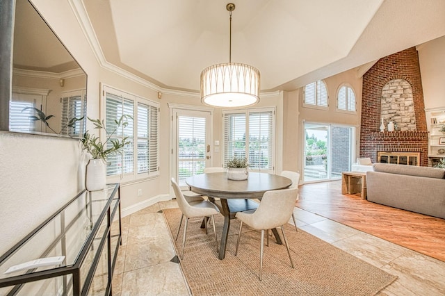 dining area featuring lofted ceiling, ornamental molding, a fireplace, and light tile patterned floors