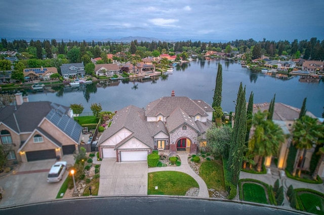 birds eye view of property with a water view and a residential view