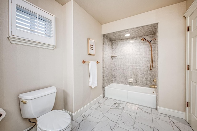 bathroom featuring baseboards, tub / shower combination, marble finish floor, and toilet