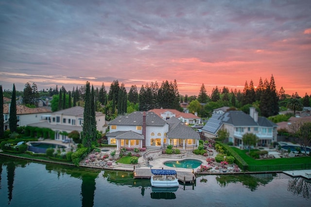 back of property featuring an outdoor pool, a residential view, a water view, and a patio