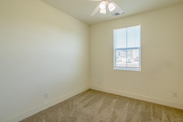 empty room with ceiling fan, visible vents, baseboards, and light carpet