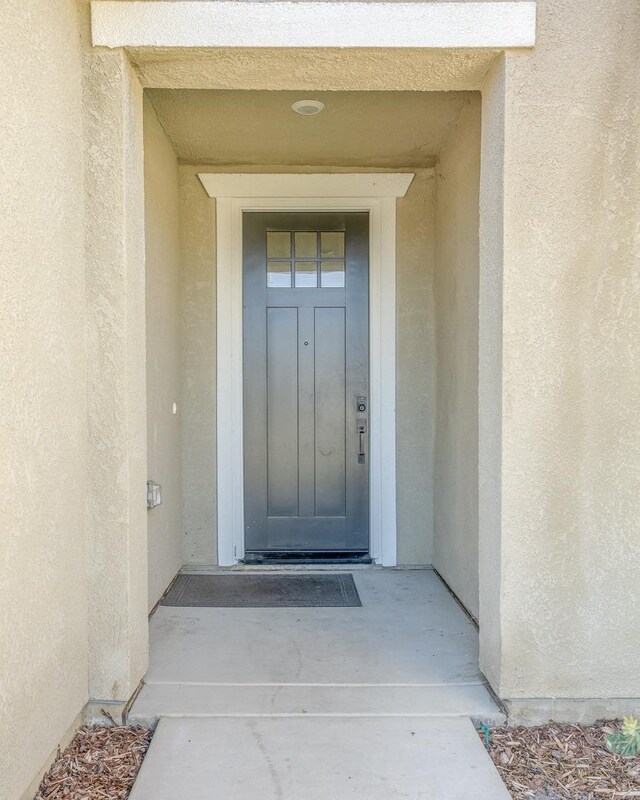 property entrance with stucco siding