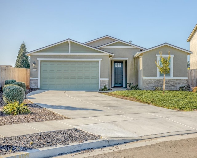 ranch-style home featuring concrete driveway, fence, stone siding, and a garage