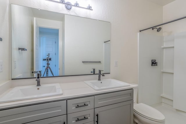 bathroom with a sink, a shower, and toilet