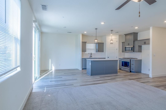 kitchen featuring gray cabinets, baseboards, stainless steel appliances, and visible vents