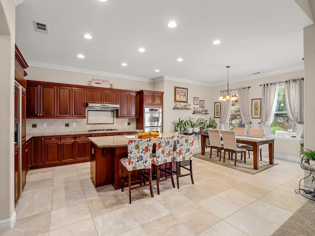 10640 N Old Course Dr, Fresno, CA 93730 - kitchen with recessed lighting, stainless steel double oven, under cabinet range hood, backsplash, and gas cooktop