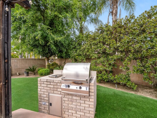 10640 N Old Course Dr, Fresno, CA 93730 - view of patio featuring a fenced backyard, a grill, and exterior kitchen