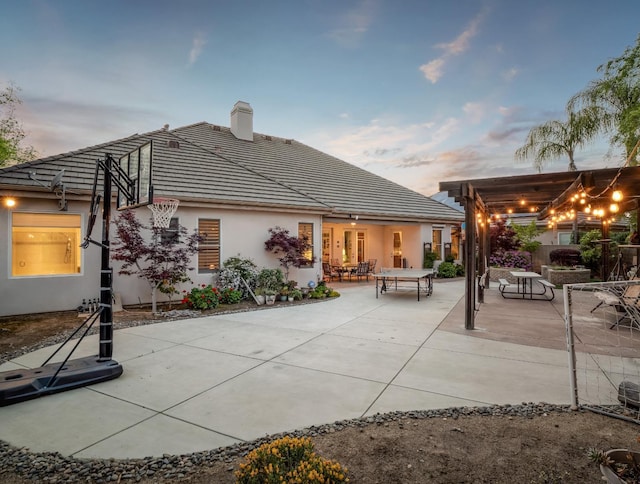 10640 N Old Course Dr, Fresno, CA 93730 - rear view of house featuring stucco siding, a tile roof, a chimney, and a patio
