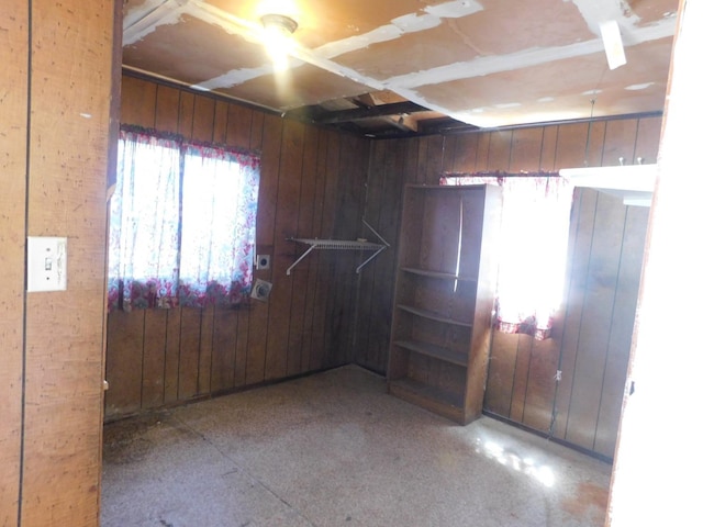 empty room featuring wooden walls